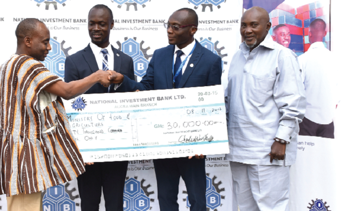 Mr Charles Wordey (3rd left), Head of Corporate Affairs, NIB presenting the cheque to Dr Sagre Bambangi, a deputy Minister of Food and Agriculture